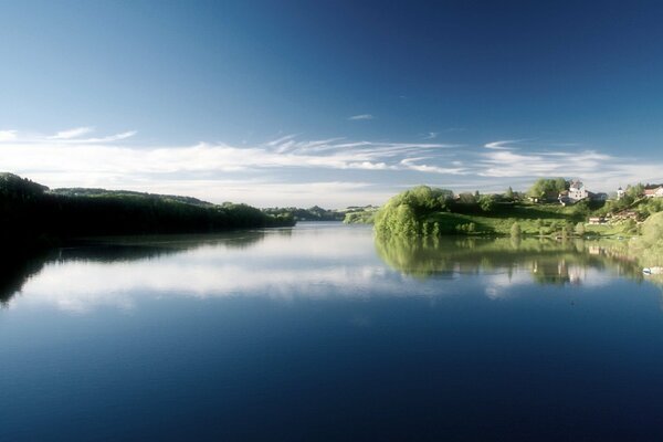 A pond near the village. Blue sky