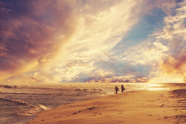 People surfing on the seashore