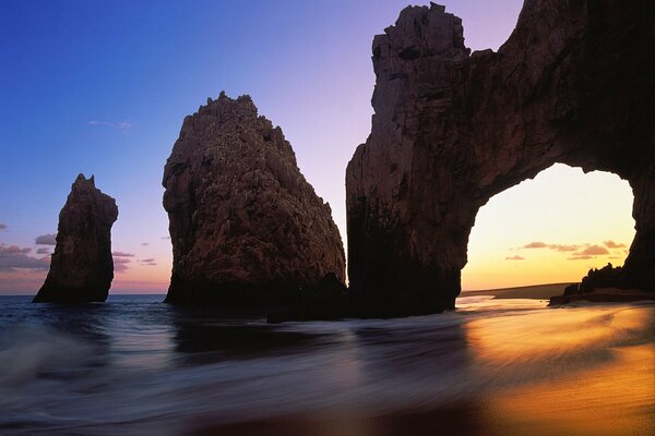 Mountains with sea waves, sunset