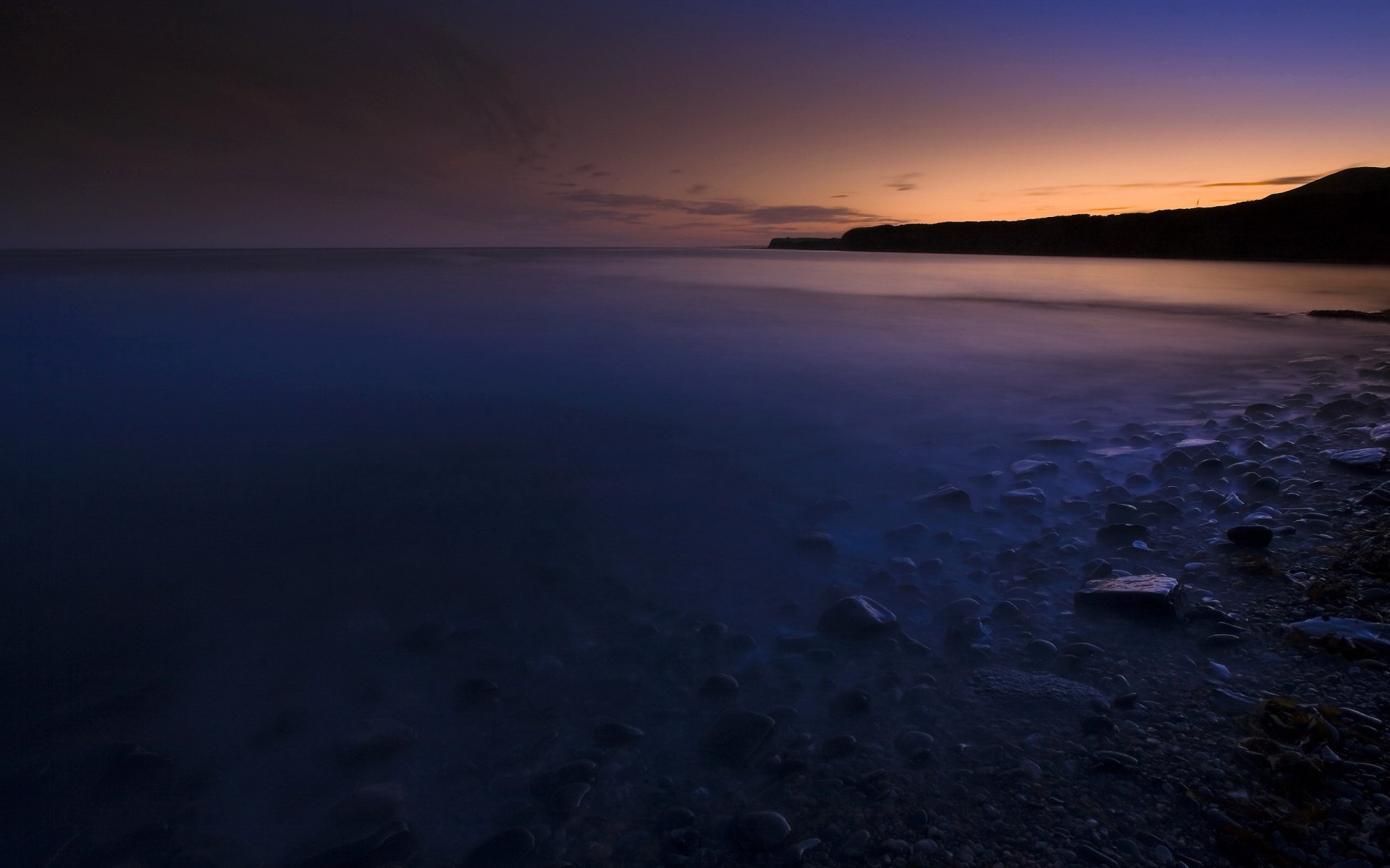 mare acqua pietre riva tramonto sera
