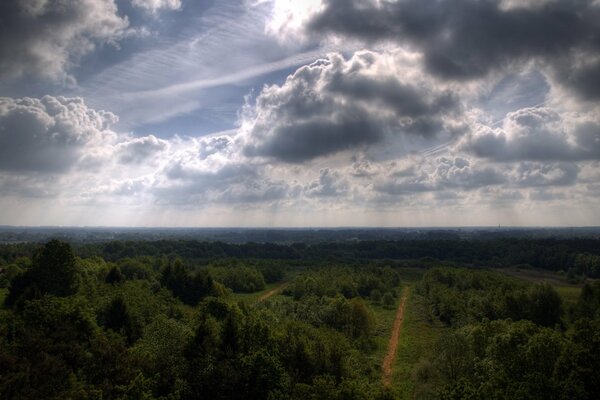 Clouds and a long road towards the trees