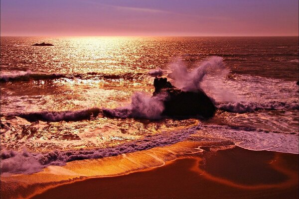 Sea waves on the shore at sunset