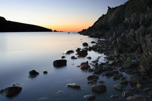 Black wet rocks on the shore