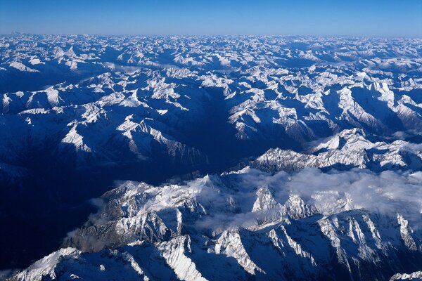 The peaks of snow-capped mountains. Mountain ranges