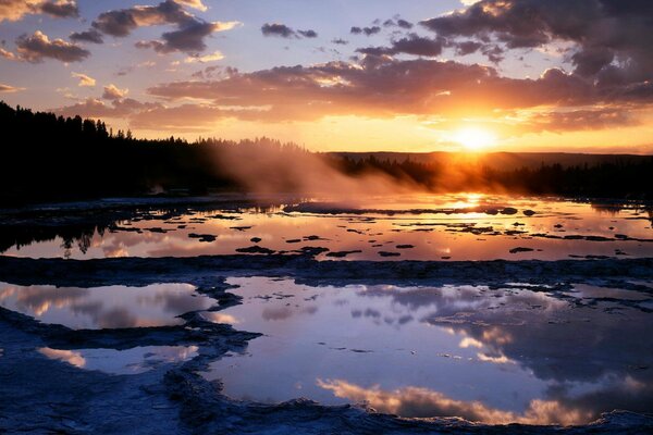 Sunset over a forest swamp