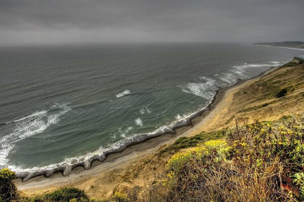 Thunderstorm. The shore by the raging sea