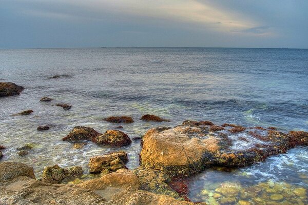 The stone shore by the calm sea