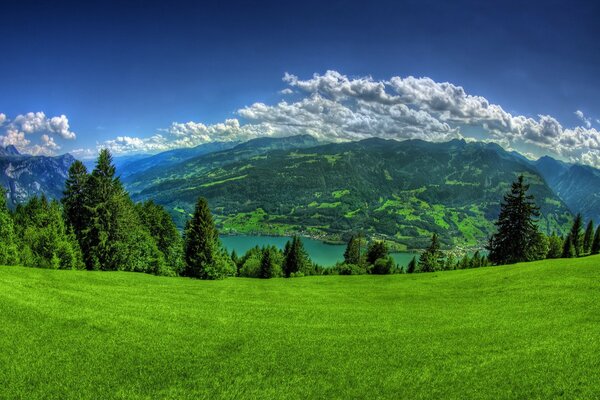 Beautiful landscape of mountains, green grass, river