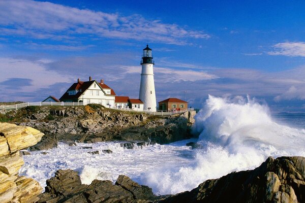 A house with a lighthouse on the rocky shore