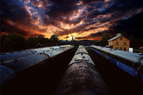 Scarlet sunset over trains