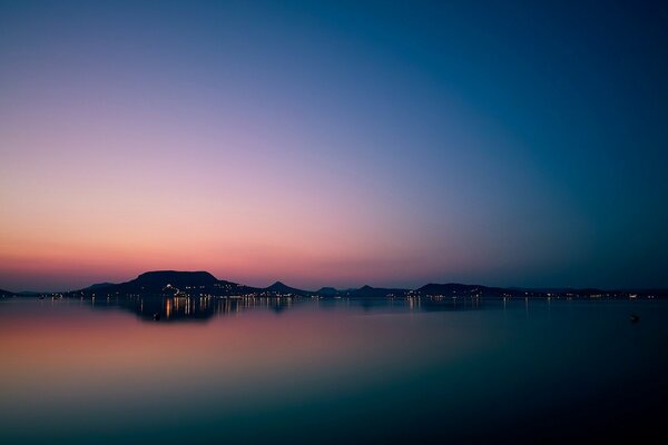 A mirror image of the city and the sky in a pond