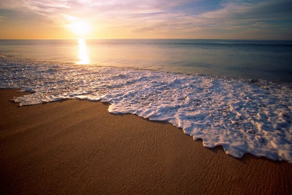 Waves caress the sandy beach