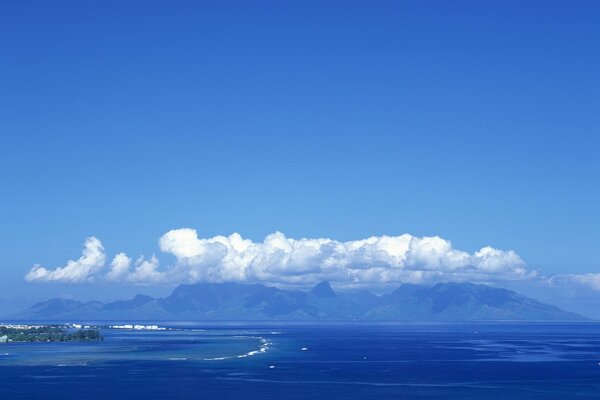 Clouds mountains and sea in blue tones