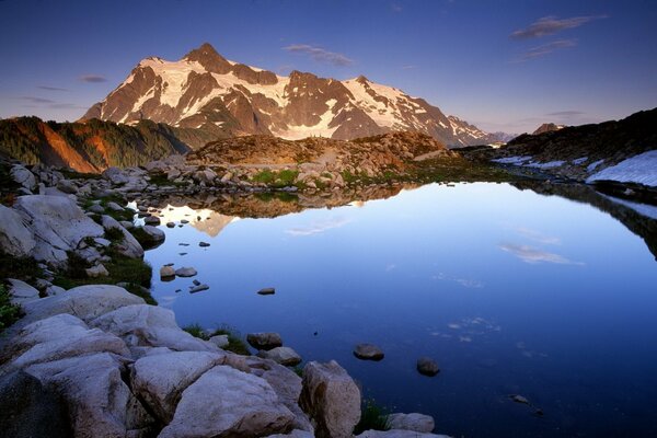 Blue lake with a rocky shore in the mountains