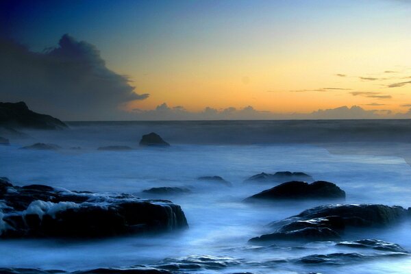 Sea foam wrapped the rocks with its thick blanket