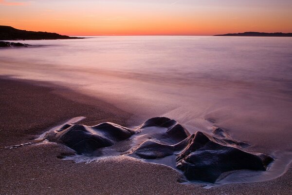 Sandy beach with large stones on exposure