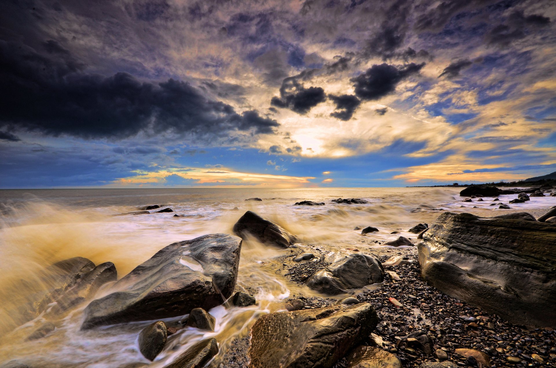 ea beach stones waves spray clouds sunset