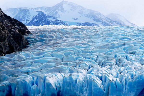 Mountain peaks behind ice blocks