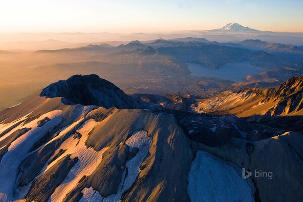 Snow-capped mountain peaks in the rays of dawn