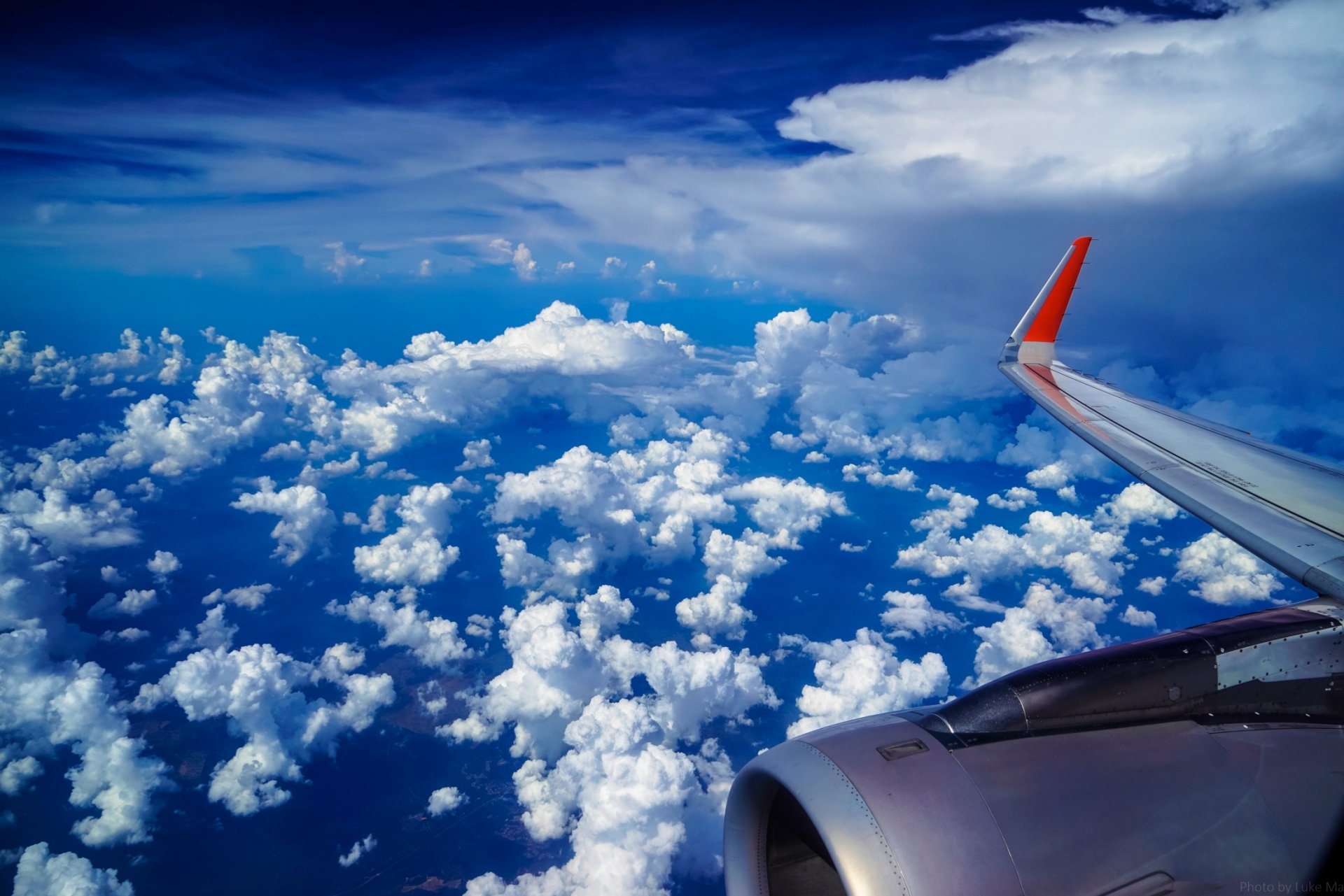 under the wing of the aircraft plane wing sky cloud