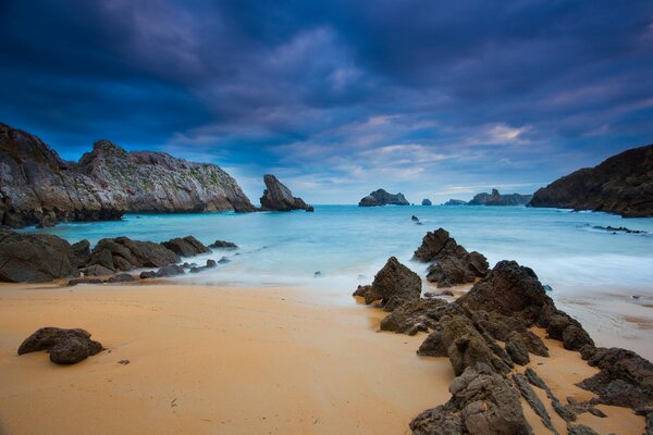 Sunset over the sandy beach of the ocean