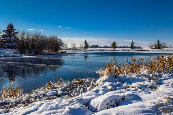 Snow near the river coast