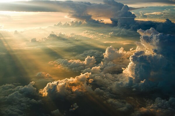 The rays of the sun at sunrise play with the clouds