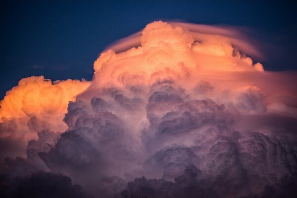 Huge clouds with bright colors of sunset