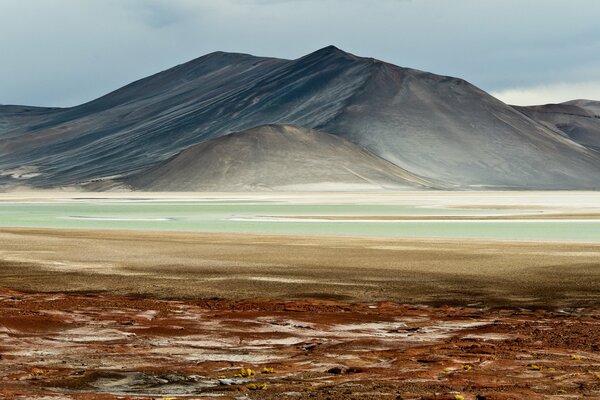 Blue river on the background of gray mountains