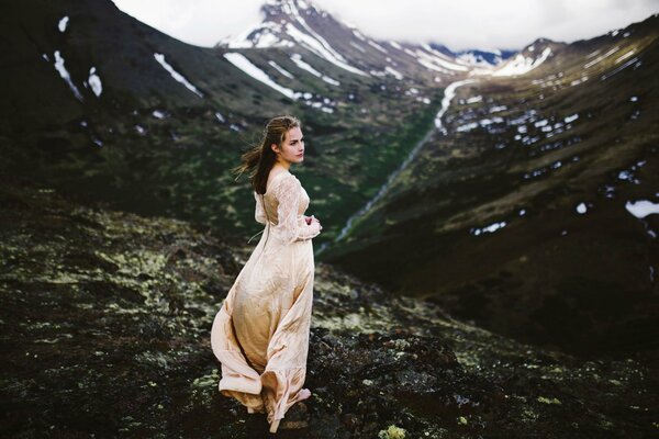 Mädchen im weißen Kleid auf dem Hintergrund der Berge