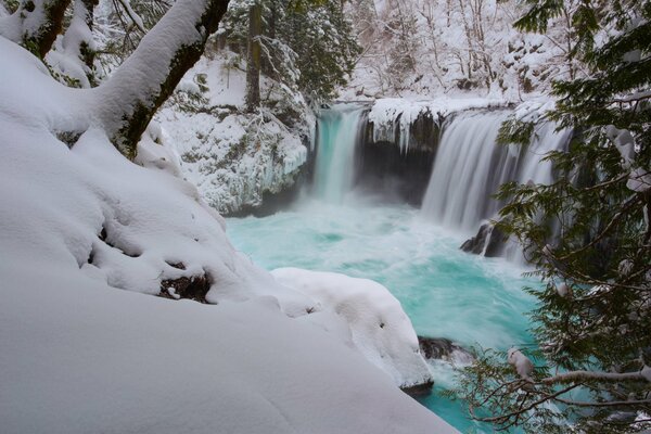 Ice-free azure waterfall in winter