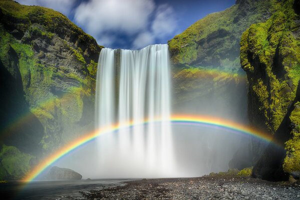 Unreal view of waterfall and rainbow