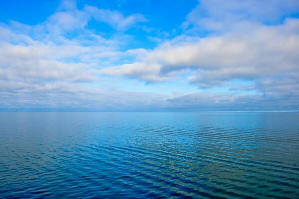 Wolken über dem blauen Meer in Ruhe