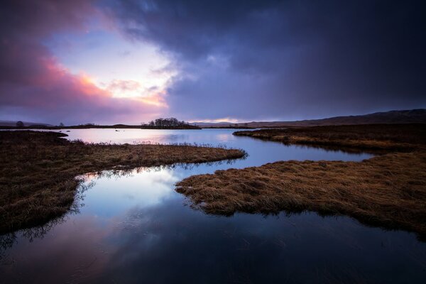 Sonnenaufgang am See in Schottland