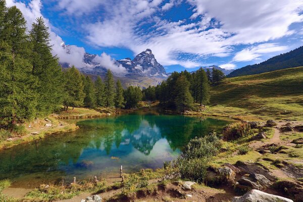 Lago pintoresco con el fondo de montañas y bosques