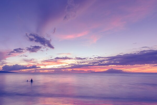 A beautiful purple sunset and a man
