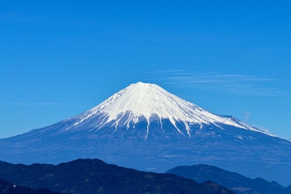 A mountain with a white cap of snow