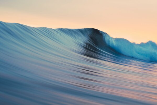 Sunset reflection on the crest of the wave