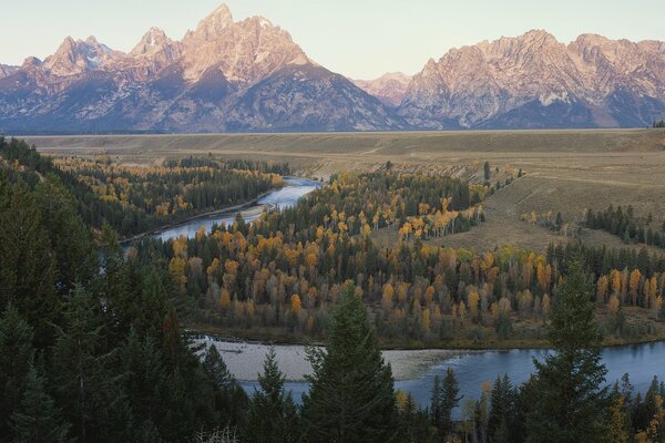 Mountain river at the snow-capped peaks