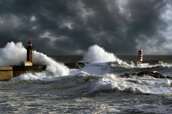 Storm on the shore with waves over the lighthouse