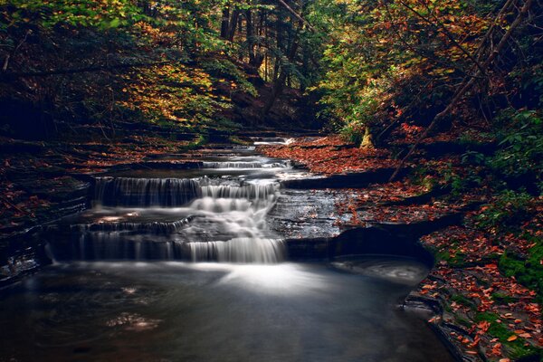 The endlessly flowing water of the autumn waterfall