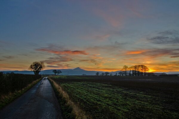 The road to the mountains at sunset