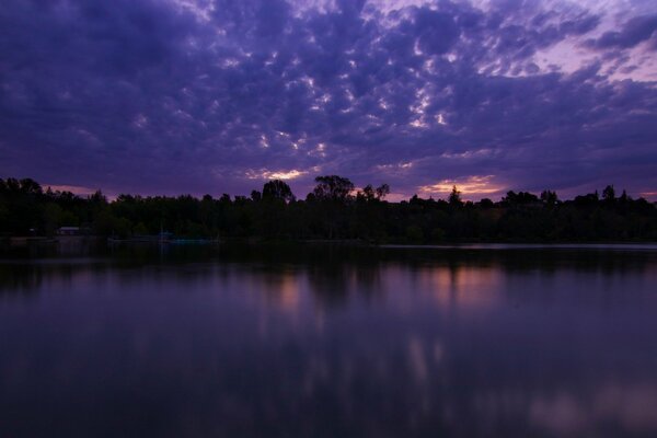 Purple twilight is reflected in the lake