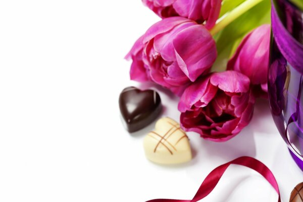 Two chocolates and pink tulips