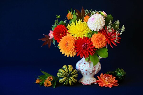 Flowers in a vase on a blue background. Still-life