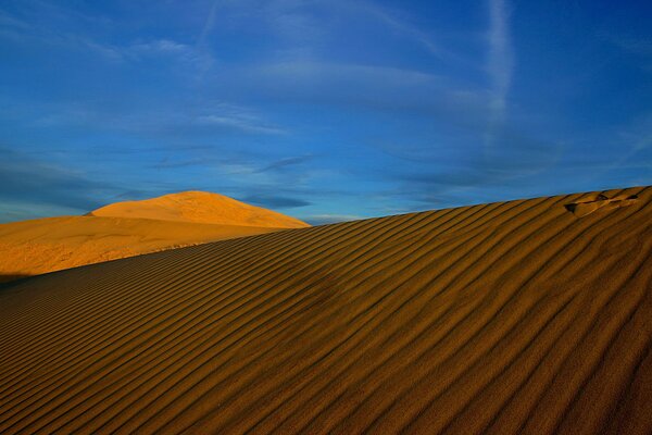 Sand dunes in a hot, sunny desert