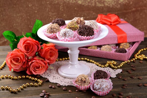 There are sweets and a bouquet of flowers on the table