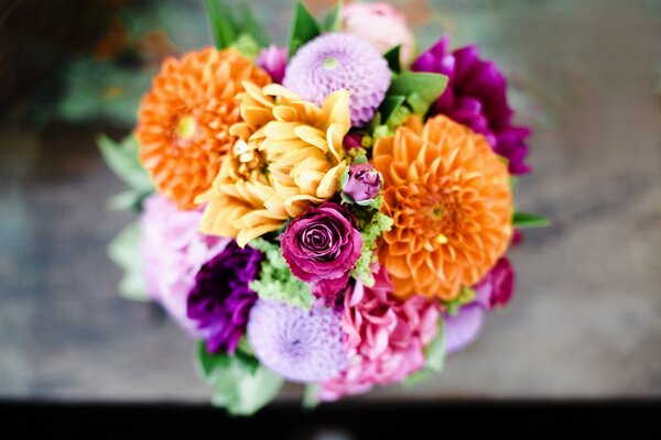 Bouquet of lilac roses and colorful dahlias