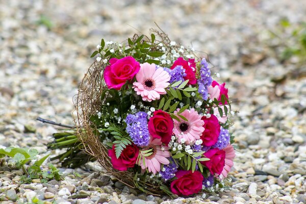 Bouquet of gerberas and roses on a pebble