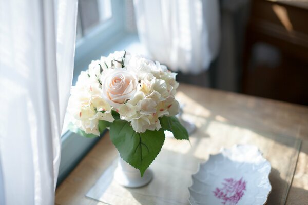 Background a vase of flowers is on the table